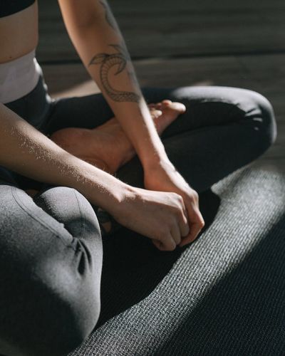 A close-up view of a person's hands in a meditative pose.